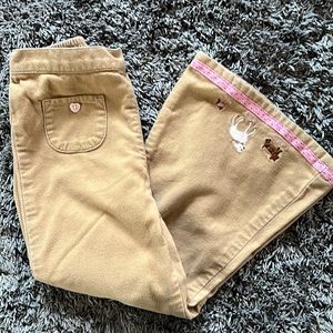 Gymboree soft khaki pants with puppies on the bottom of wide legged pants.